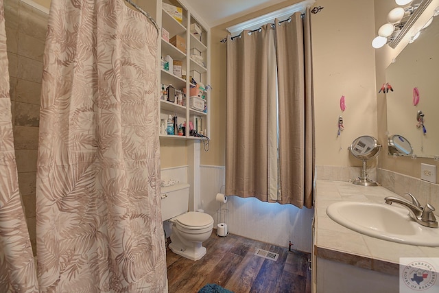 bathroom featuring hardwood / wood-style flooring, toilet, and vanity