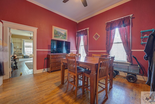 dining room featuring wood-type flooring, ceiling fan, and ornamental molding