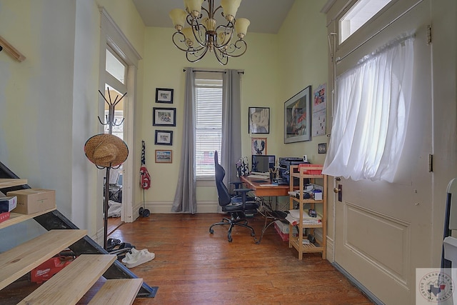 home office featuring hardwood / wood-style floors and a chandelier