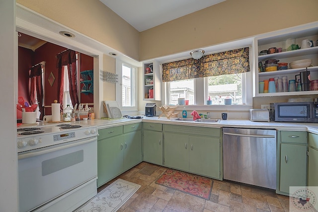 kitchen with sink, appliances with stainless steel finishes, and green cabinets