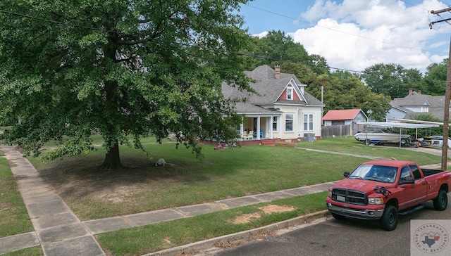 view of front facade featuring a front yard, a porch, and a carport