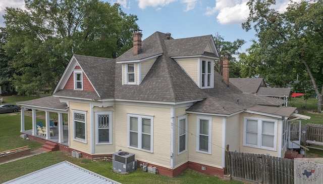 back of house featuring a porch and a yard