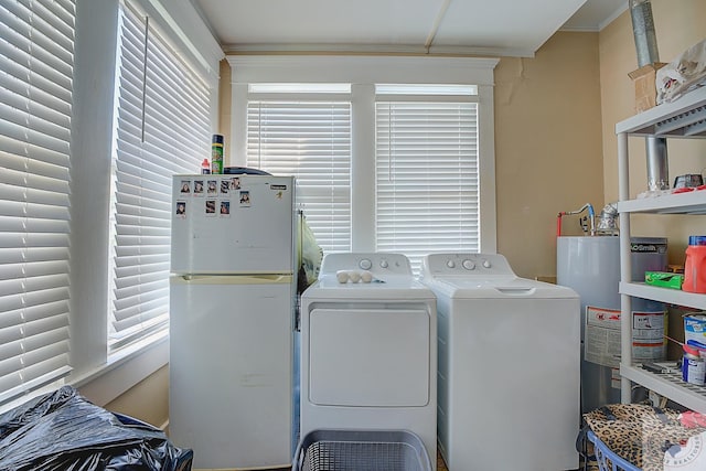 clothes washing area with washer and dryer and water heater