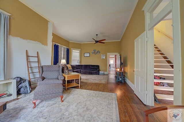 living room with ceiling fan, dark hardwood / wood-style flooring, and ornamental molding