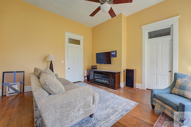 living room featuring wood-type flooring and ceiling fan