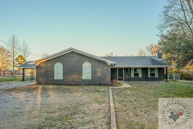 single story home with a carport and a front lawn