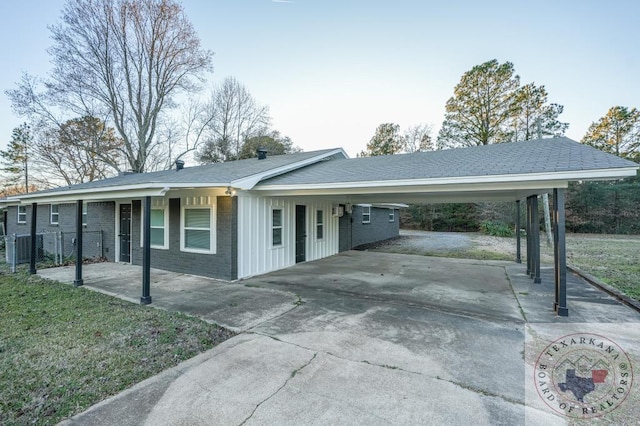 exterior space with a carport and a front lawn