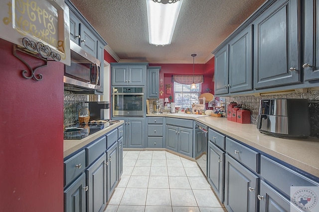 kitchen featuring sink, hanging light fixtures, appliances with stainless steel finishes, and gray cabinets