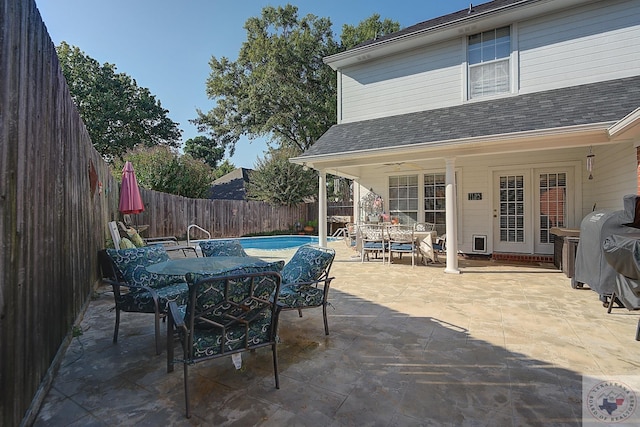 view of patio featuring ceiling fan, a fenced in pool, and grilling area