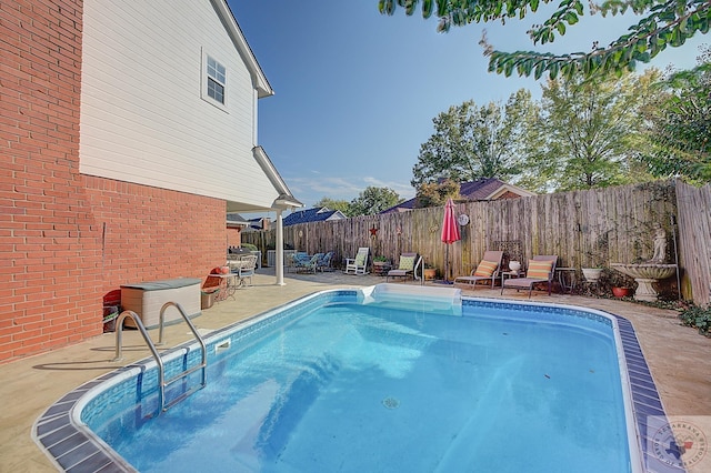 view of swimming pool with a patio area