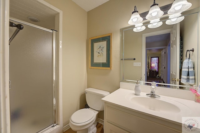 bathroom with a textured ceiling, toilet, a shower with shower door, a notable chandelier, and vanity