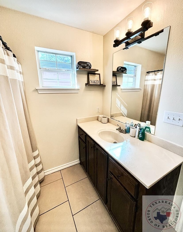 bathroom with tile patterned flooring and vanity