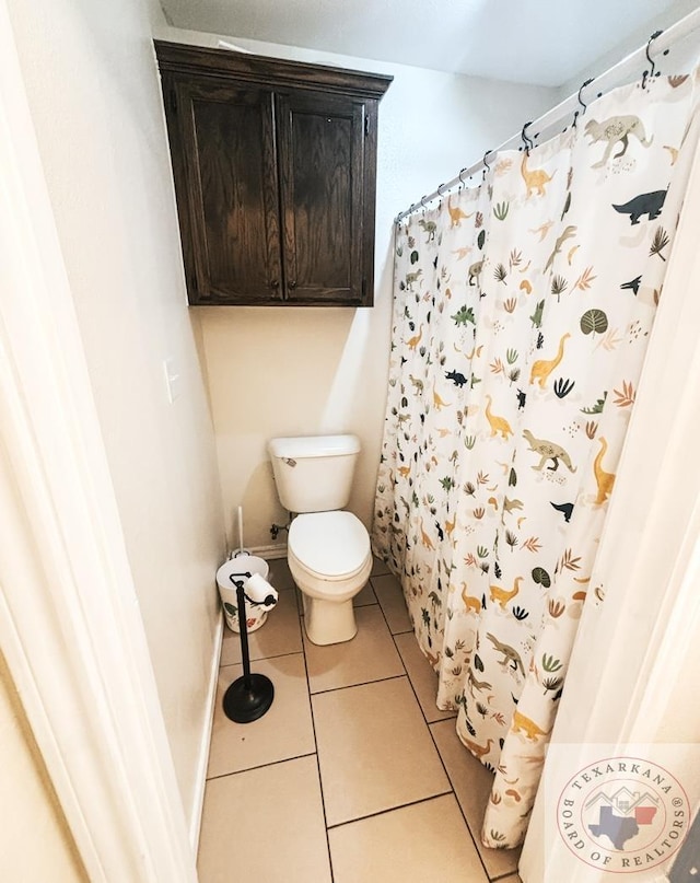 bathroom with toilet and tile patterned flooring