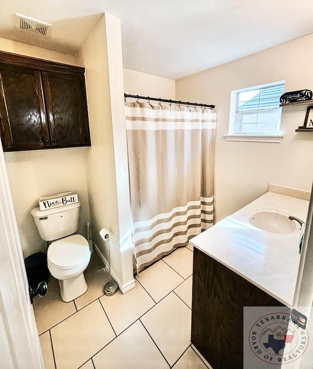 full bathroom with tile patterned flooring, vanity, shower / bath combo with shower curtain, and toilet