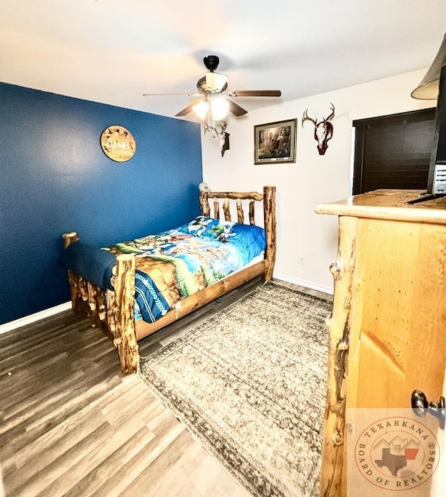 bedroom with ceiling fan and hardwood / wood-style floors