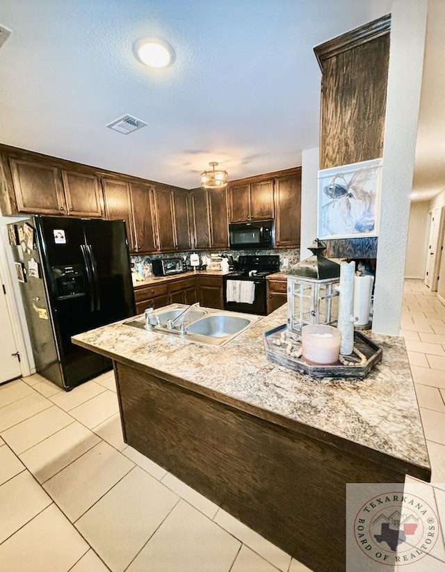 kitchen featuring sink, dark brown cabinetry, black appliances, light tile patterned flooring, and kitchen peninsula