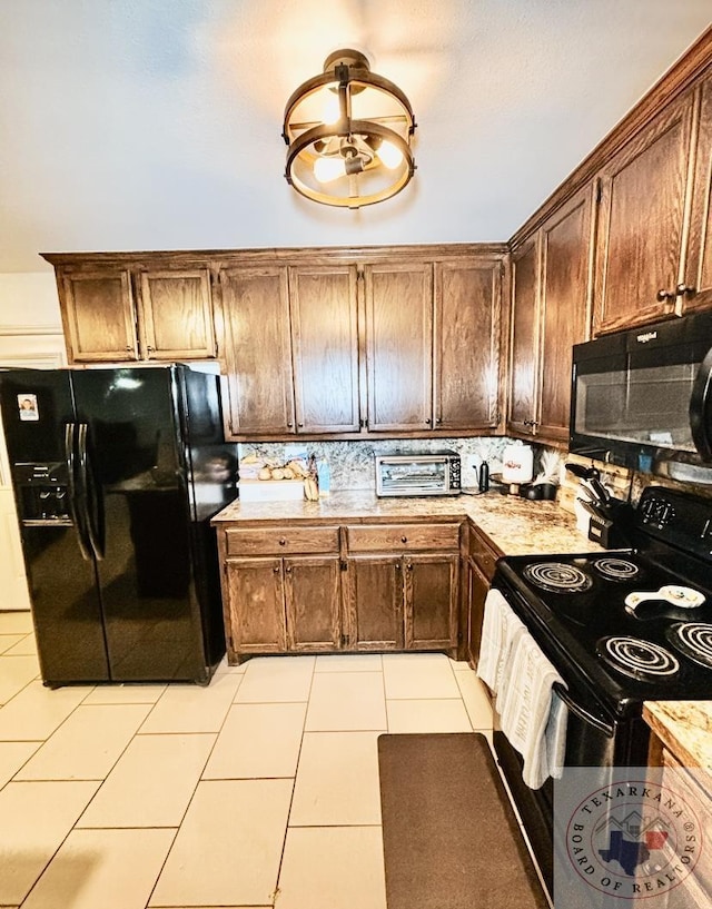 kitchen with light tile patterned floors and black appliances