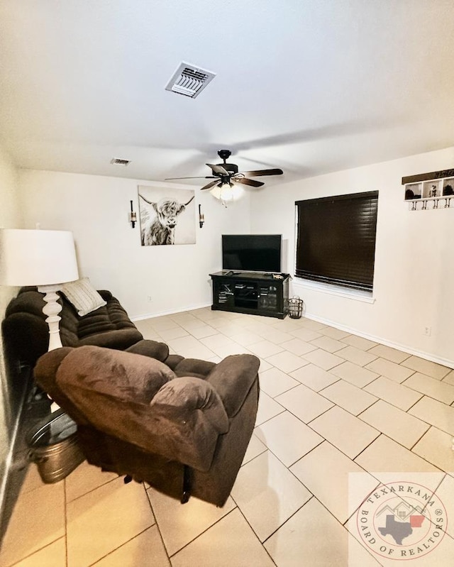 tiled living room with ceiling fan