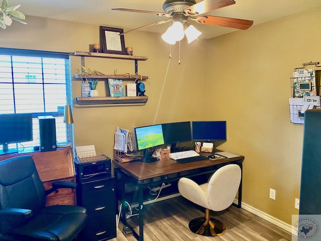 home office with wood-type flooring and ceiling fan