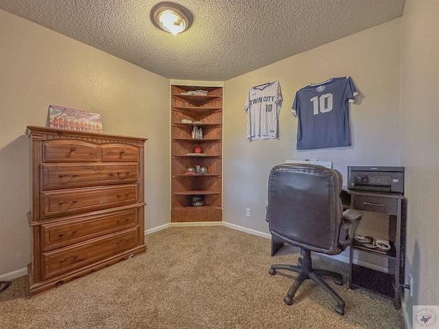 carpeted office featuring built in shelves and a textured ceiling