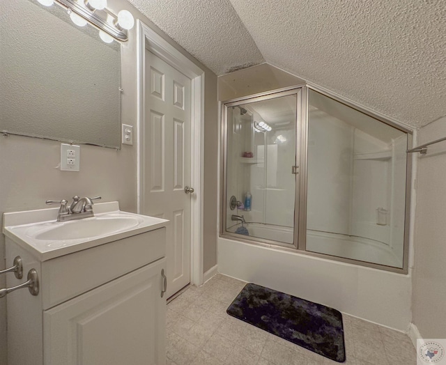 bathroom with vanity, combined bath / shower with glass door, a textured ceiling, and lofted ceiling