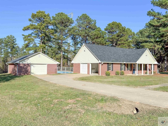 view of front of home featuring a garage, a front yard, and covered porch