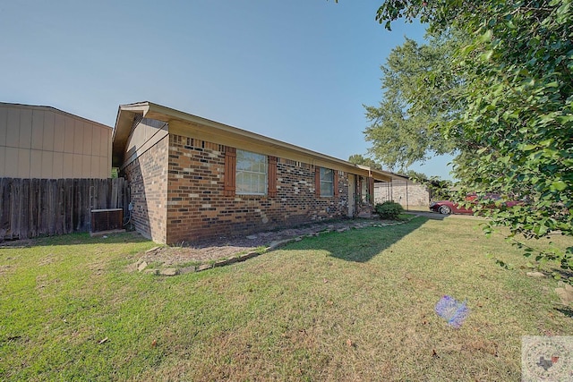 view of home's exterior with central AC unit and a lawn