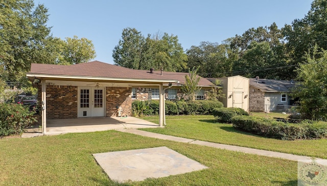 rear view of property with a patio area, a lawn, and ceiling fan