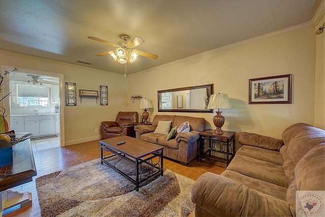 living room with sink, light hardwood / wood-style flooring, ceiling fan, and ornamental molding