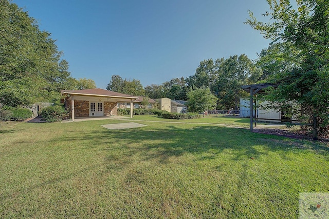 view of yard featuring a patio and french doors