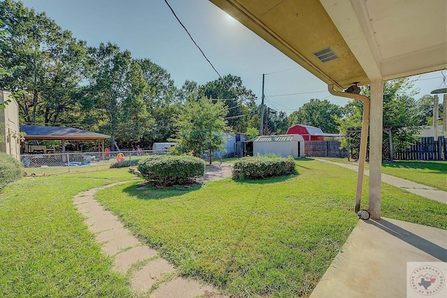 view of yard with a gazebo and a storage unit