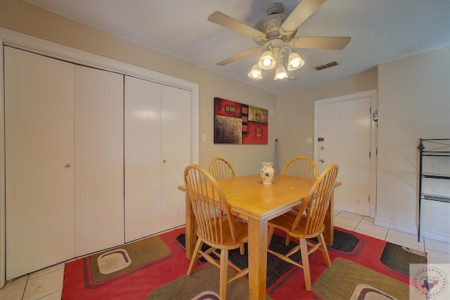 tiled dining space with ceiling fan