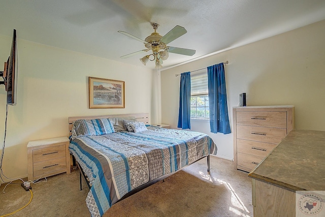 bedroom featuring ceiling fan and light carpet