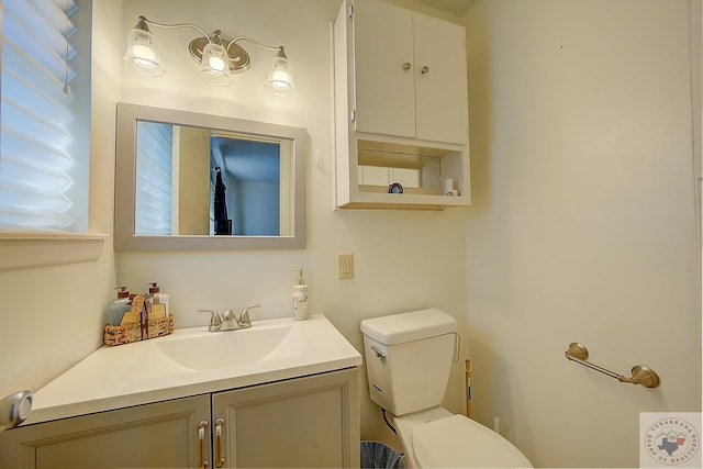 bathroom featuring toilet and vanity