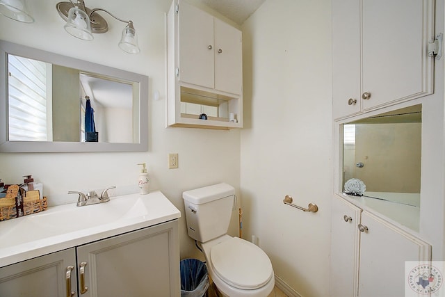 bathroom with toilet and vanity