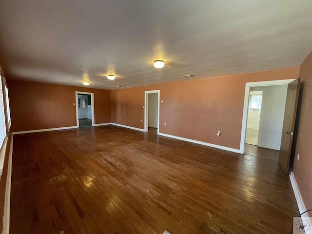 empty room with dark hardwood / wood-style flooring