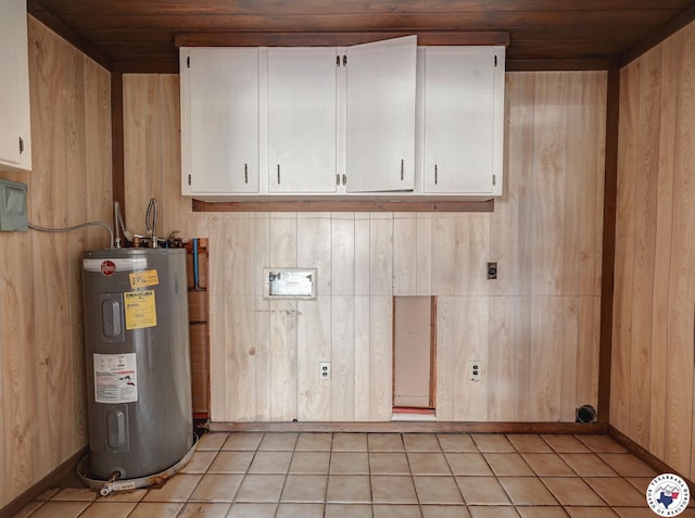 903 Mimosa St, Wake Village, TX 75501 - laundry area with electric water heater, cabinet space, hookup for an electric dryer, wood ceiling, and light tile patterned flooring