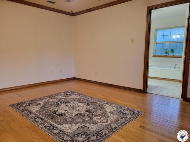 1121 Kelly Rd, Texarkana, TX 75501 - empty room featuring light wood finished floors, crown molding, and baseboards