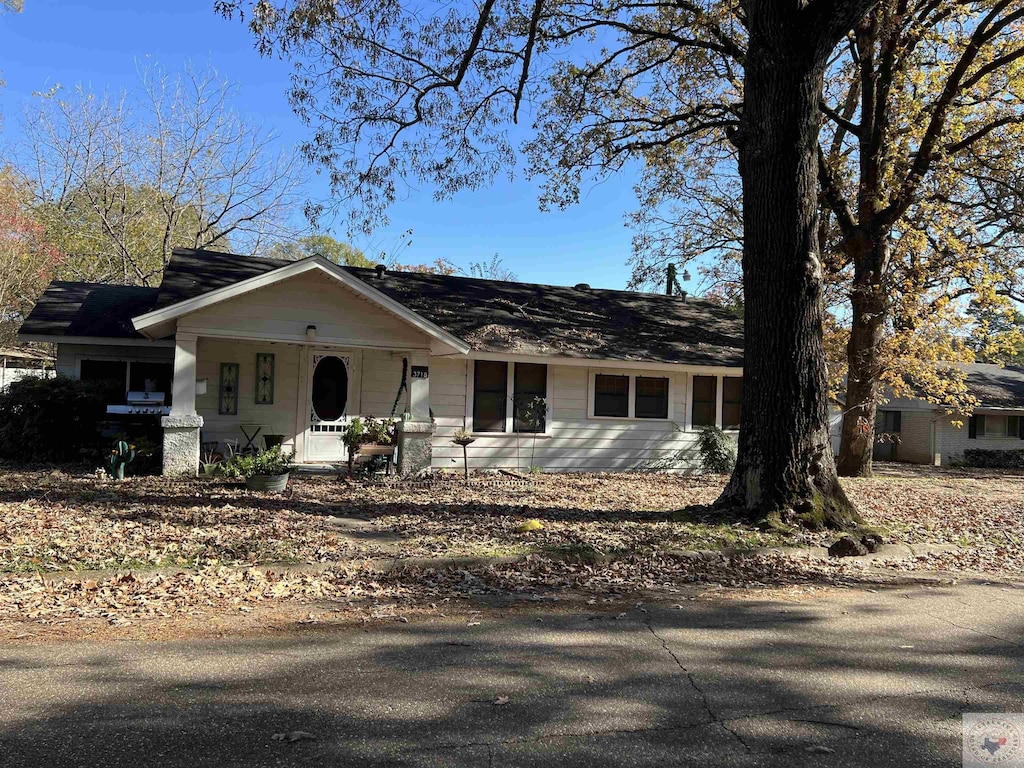 single story home featuring covered porch and a garage