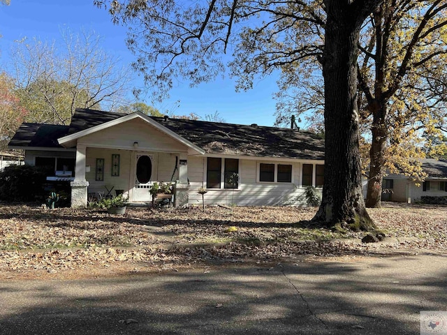 single story home featuring covered porch and a garage