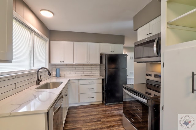 kitchen with dark wood-type flooring, sink, white cabinetry, light stone counters, and stainless steel appliances