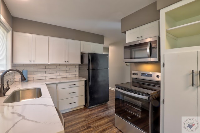 kitchen with white cabinetry, appliances with stainless steel finishes, sink, and decorative backsplash