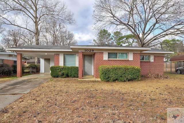 single story home with a front yard and a carport