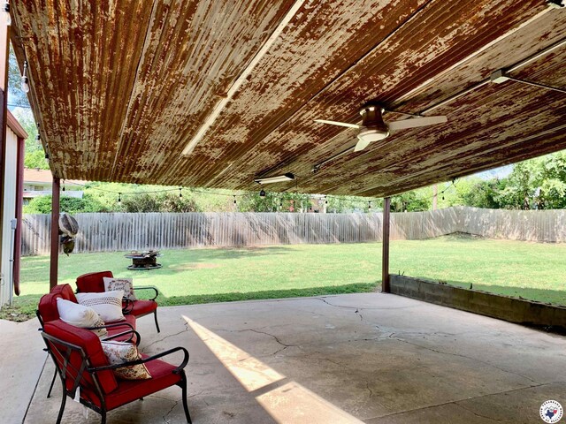 308 Eleanor St, Atlanta, TX 75551 - fenced backyard with ceiling fan and a patio area