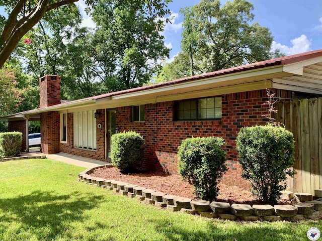 308 Eleanor St, Atlanta, TX 75551 - single story home featuring a chimney, brick siding, and a front lawn