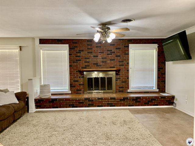 308 Eleanor St, Atlanta, TX 75551 - unfurnished living room with ceiling fan, tile patterned flooring, brick wall, and a brick fireplace