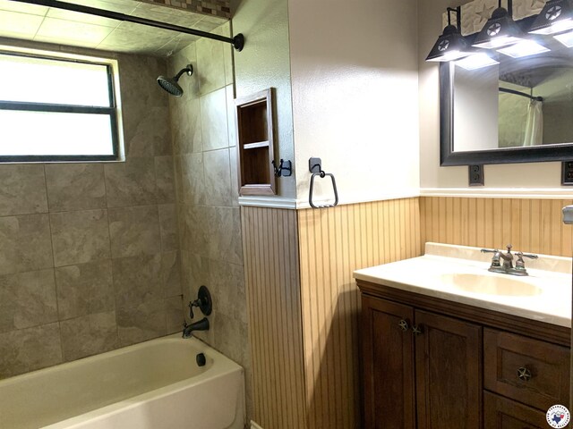 308 Eleanor St, Atlanta, TX 75551 - bathroom featuring shower / bath combination, vanity, and wainscoting