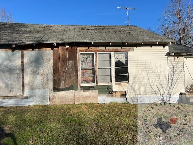 view of property exterior with a lawn