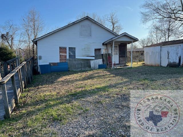 back of property with an outbuilding and fence