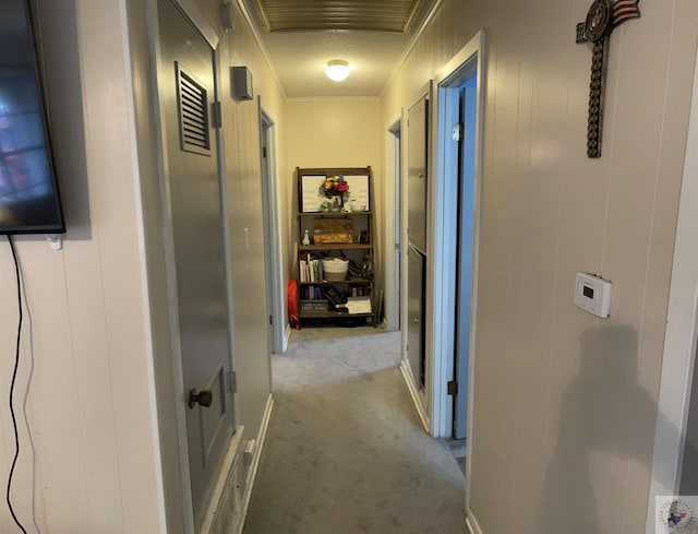 corridor featuring light carpet and ornamental molding